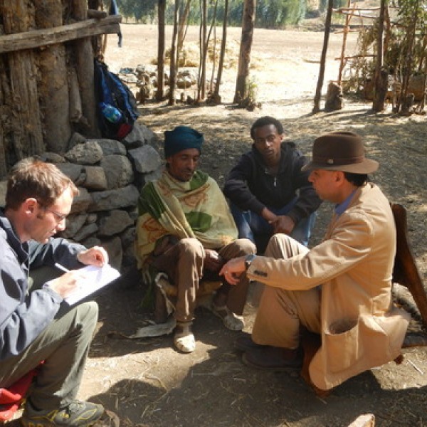 A group of people sit together outside
