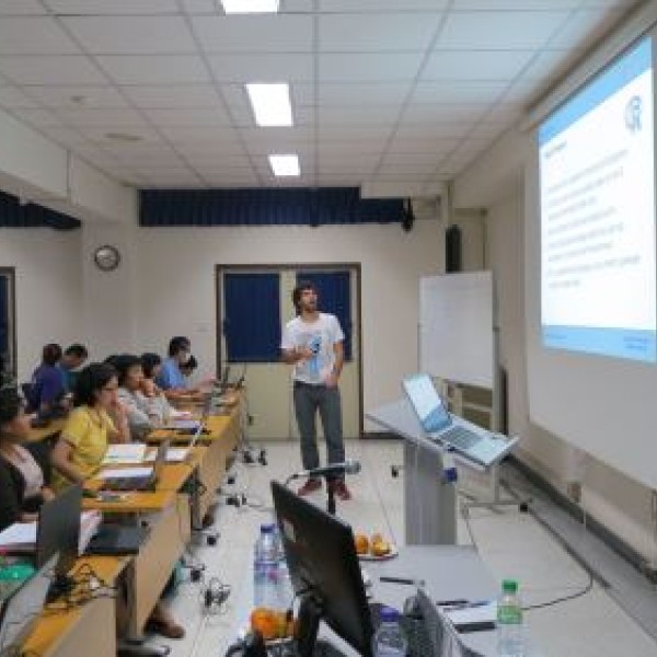 A man presents to a room full of people