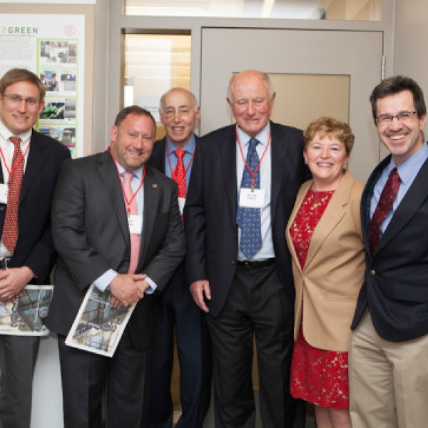 A group of people pose in front of a door