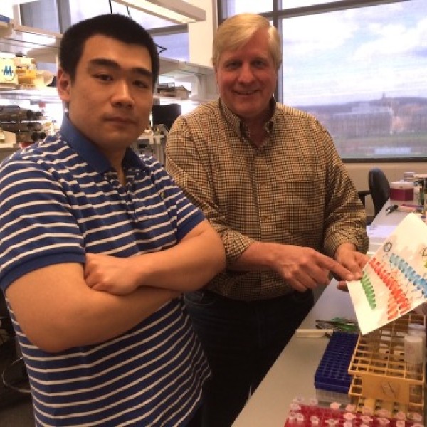 Two men standing in a laboratory