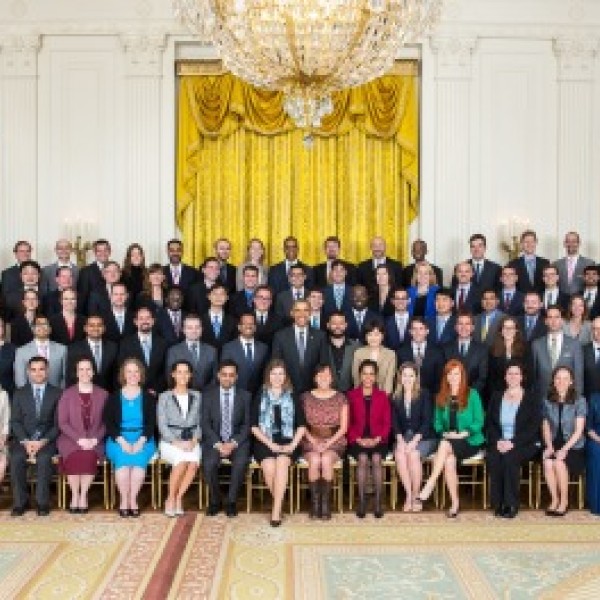 Over 100 people pose for a group photo with President Obama