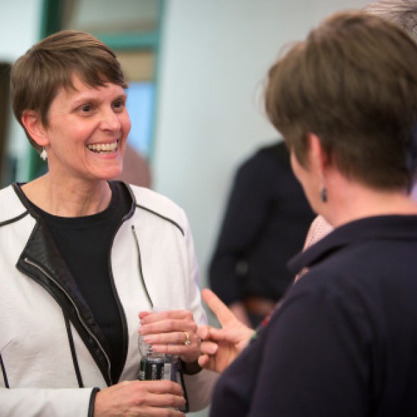 A woman speaks to two other people