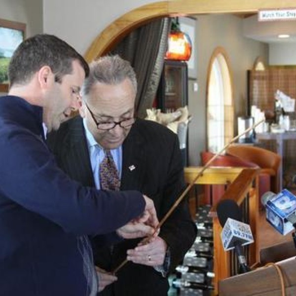 Two men stand and talk together in front of a podium