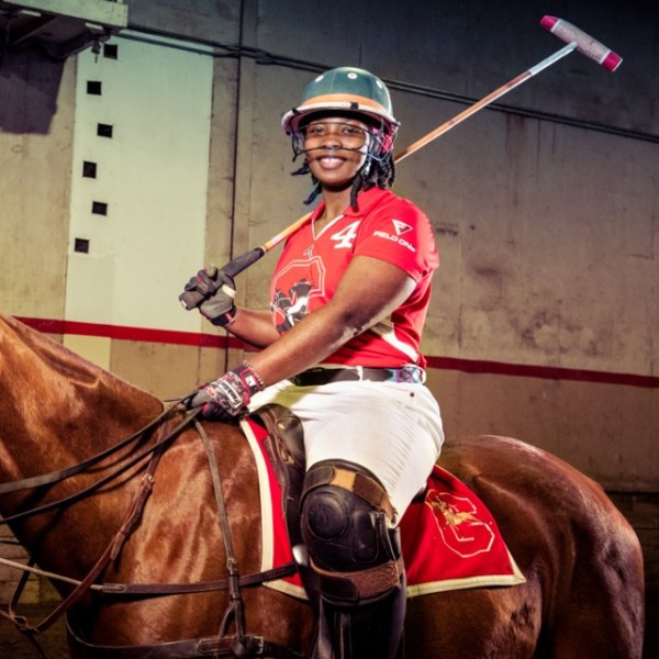 A student in a polo uniform on a horse