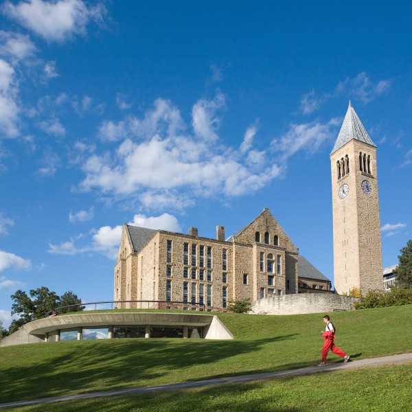 Clock tower and student jogging on campus