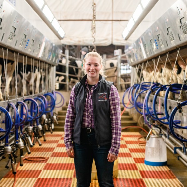 A female student standing in a dairy plant 