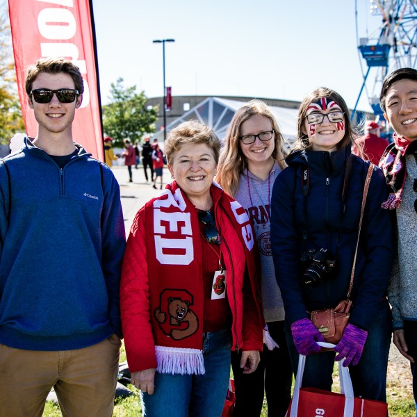 Dean Boor stands with a group of students at the 2019 Cornell Homecoming 