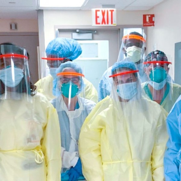 9 standing medical staff workers pose