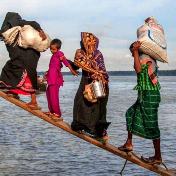 4 people board a ship wearing colorful clothing