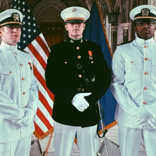Three ROTC graduates pose for their graduation portrait 