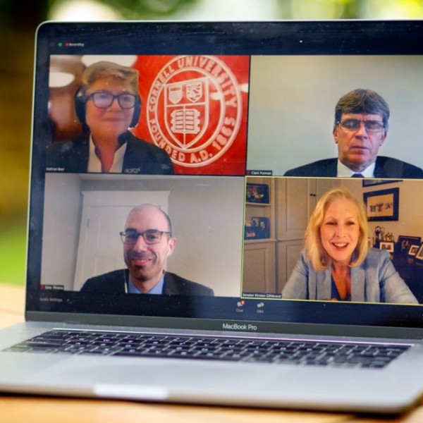 Four faces on a laptop screen