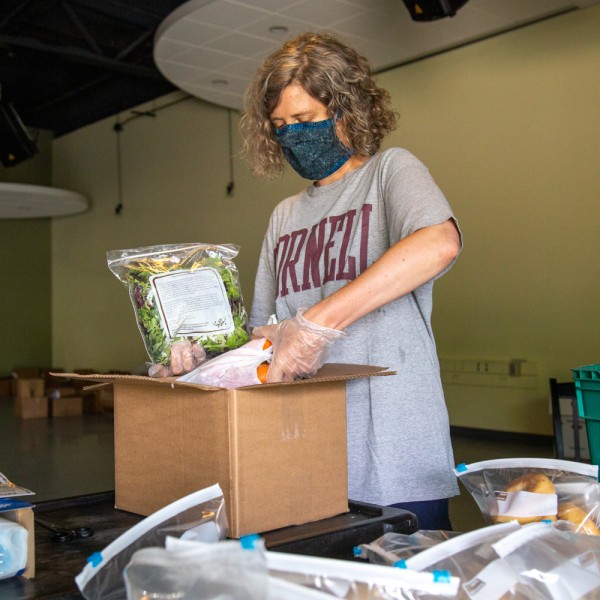 Professor packs food for delivery