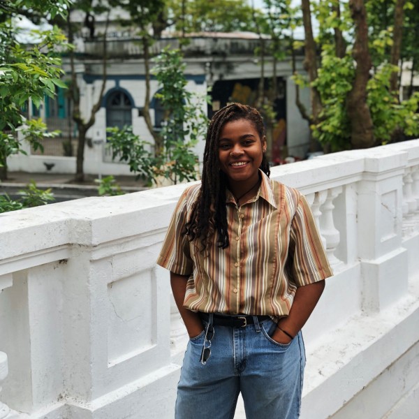Woman standing on a street with hands in pockets