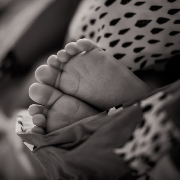 Baby feet coming out of a blanket