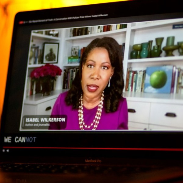 An iPad with a video playing on it of a woman speaking