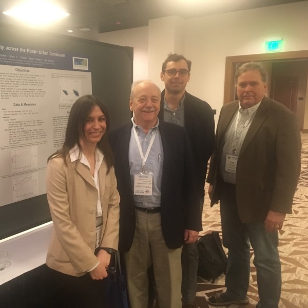 David Brown stands with group at a presentation