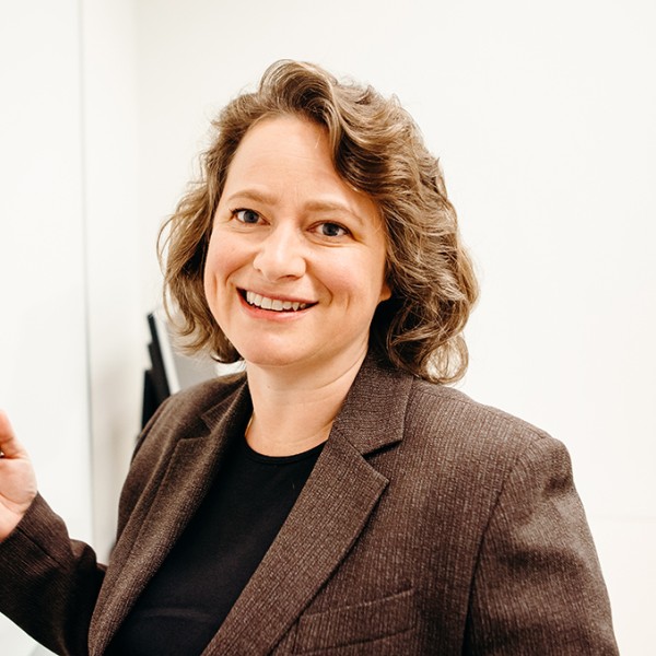 Suzanne Bliven Shu standing and talking at a white board