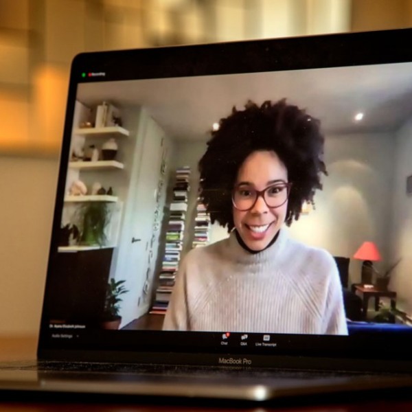 A woman speaking on a computer screen