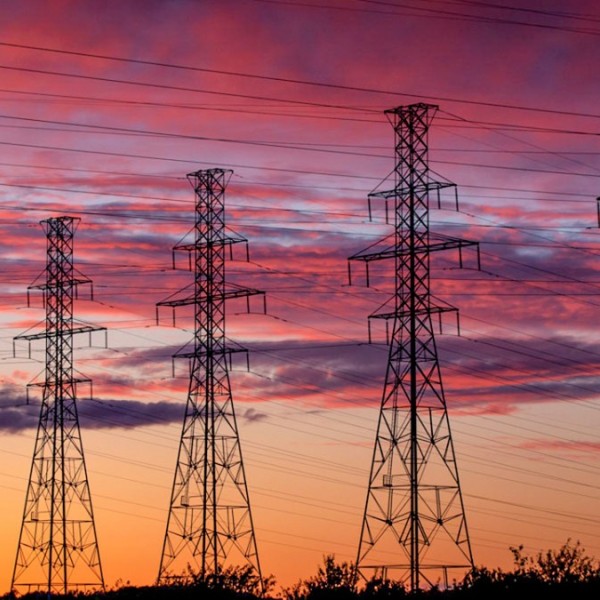 Power lines with a sunset behind them
