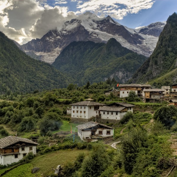 Village in a valley in Nepal with mountains in the background