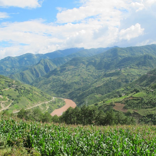 Green mountain landscape with a valley and river on a sunny day