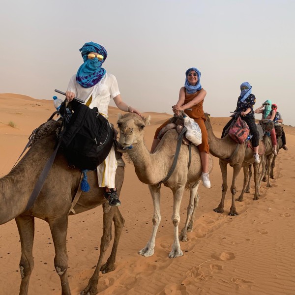 Four girls trek across the desert in Morocco on camels