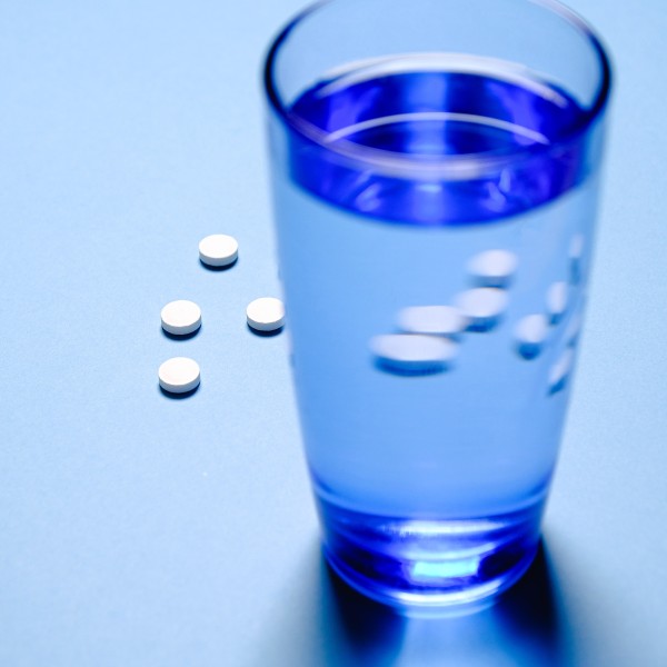 A glass of water and pills