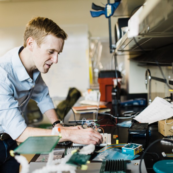 a man attaches wires to a plastic tray