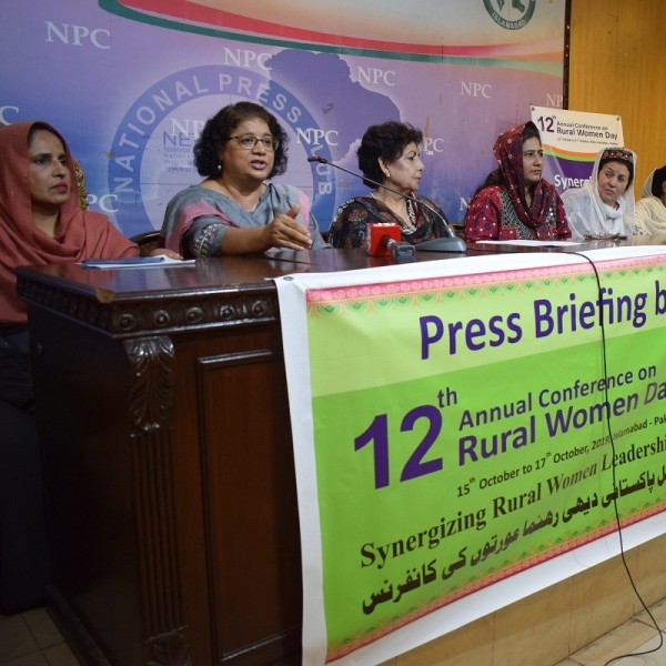 6 women sit at press conference table