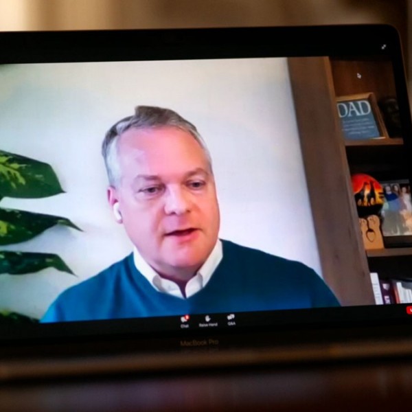 Chris Barrett speaking during a webinar on a labtop