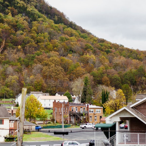 A rural town with a hillside in the background
