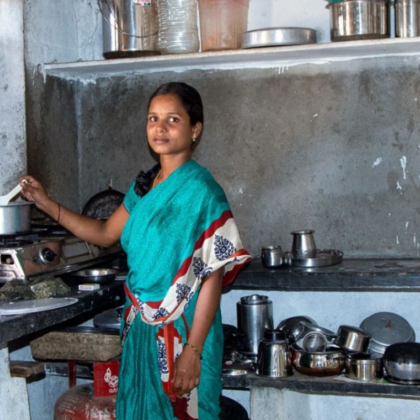A young woman prepares a meal in her home in India