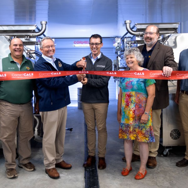 Seven people participate in the Arnot facility ribbon cutting ceremony. 