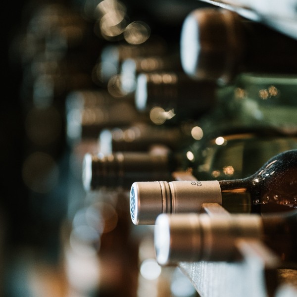 bottles of wine on a rack in a wine cellar