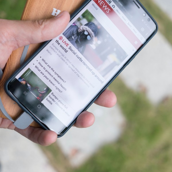 A hand holds a smart phone