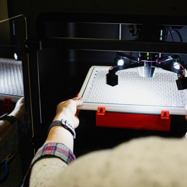 Anna Underhill calibrates a leaf disk tray in the BlackBird imaging robot