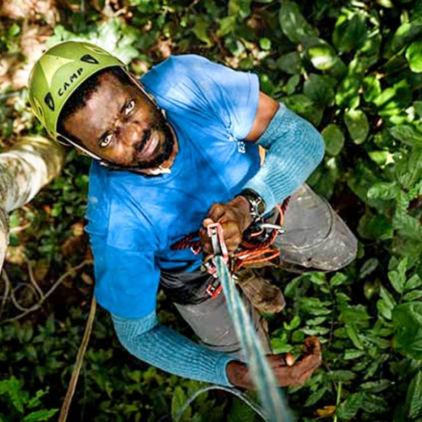 A man deploying a sound recorder in the rainforest