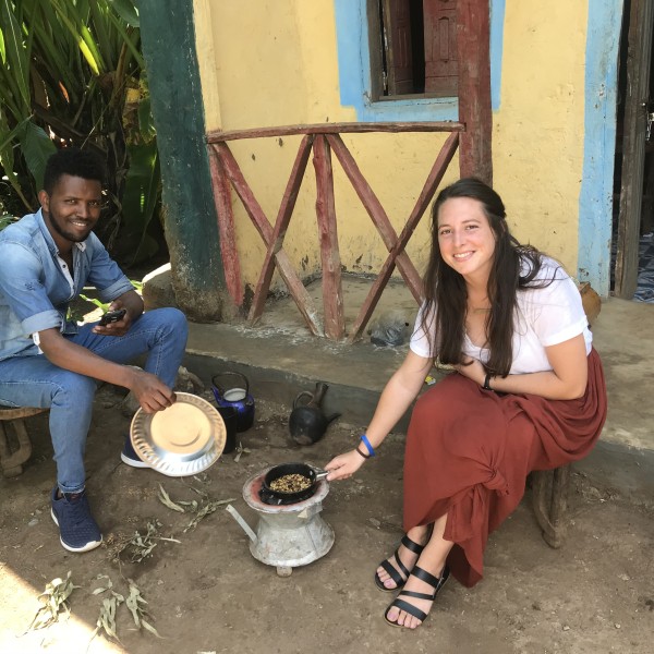 Man and woman sit and prepare food