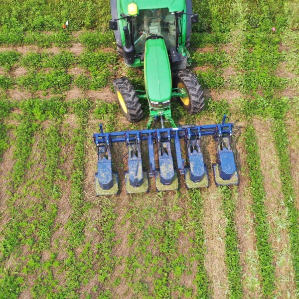 tractor with mowers mounted on the front in field