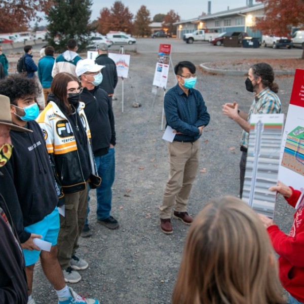 Students and faculty meet outside.