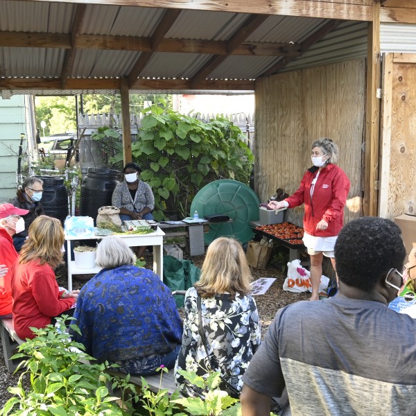 A Cornell Cooperative Extension volunteer teaches gardening lessons to a group of people