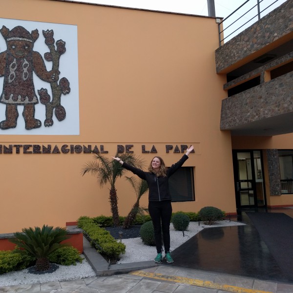 Student stands in front of the Centro Internacional de la Papa