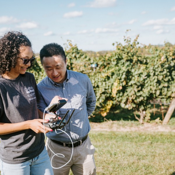 Female student and male professor operate drone