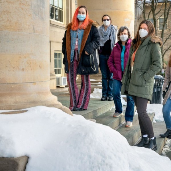 From left, Ari Broad, Rachael Skye, Beth Rhoades, Scarlett Lee, Kara Rode Webber and Kara Fikrig standing on stairs in front of a Cornell building.