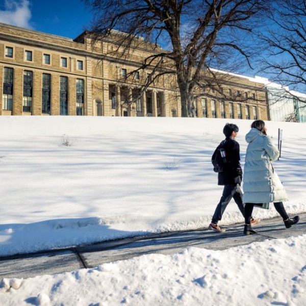 Students walk along Feeney Way on a brisk winter afternoon