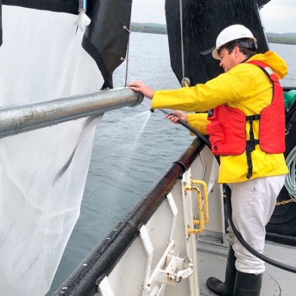 James Watkins works on a boat on Lake Ontario