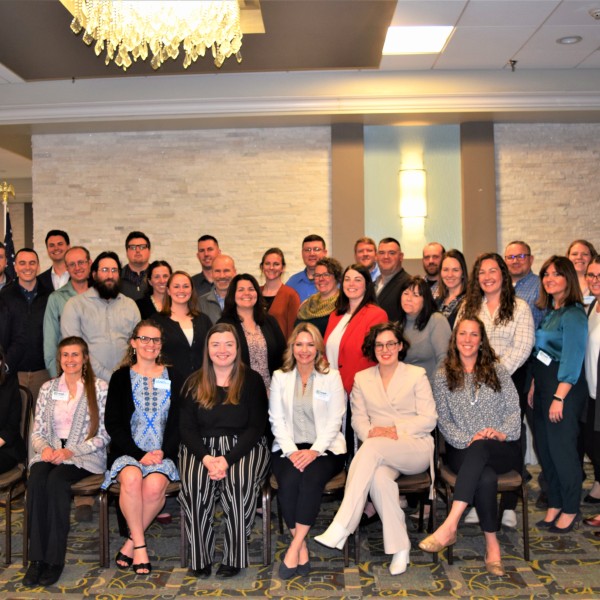 A group poses in a ballroom