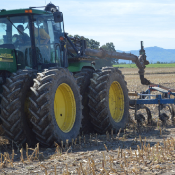 tractor driving across farm field