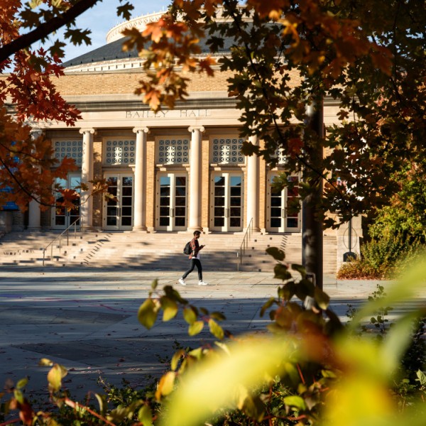 Student walks in front of campus building