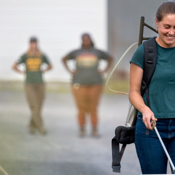 Doctoral student Maria Gannett practices a walking cadence with a sprayer full of water.